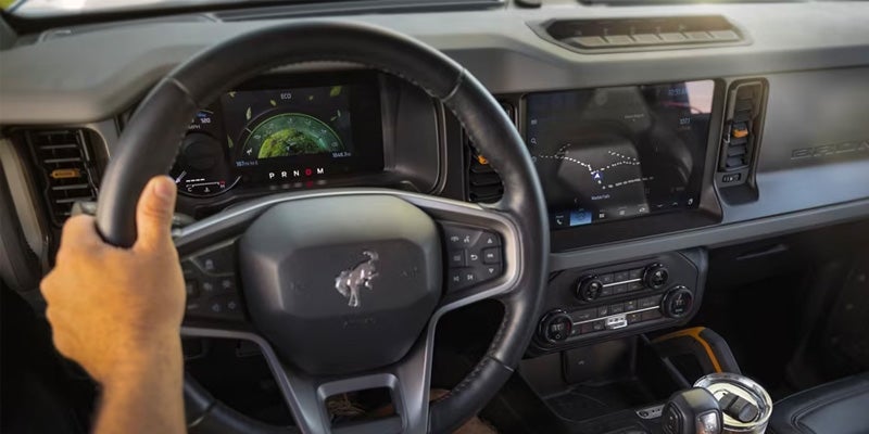 View of the steering wheel and drivers side interior of a 2024 Ford Bronco